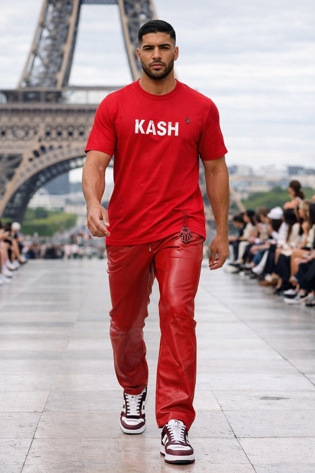 Model on the KASH runway at the Eiffel Tower in a red KASH tee and red leather trousers